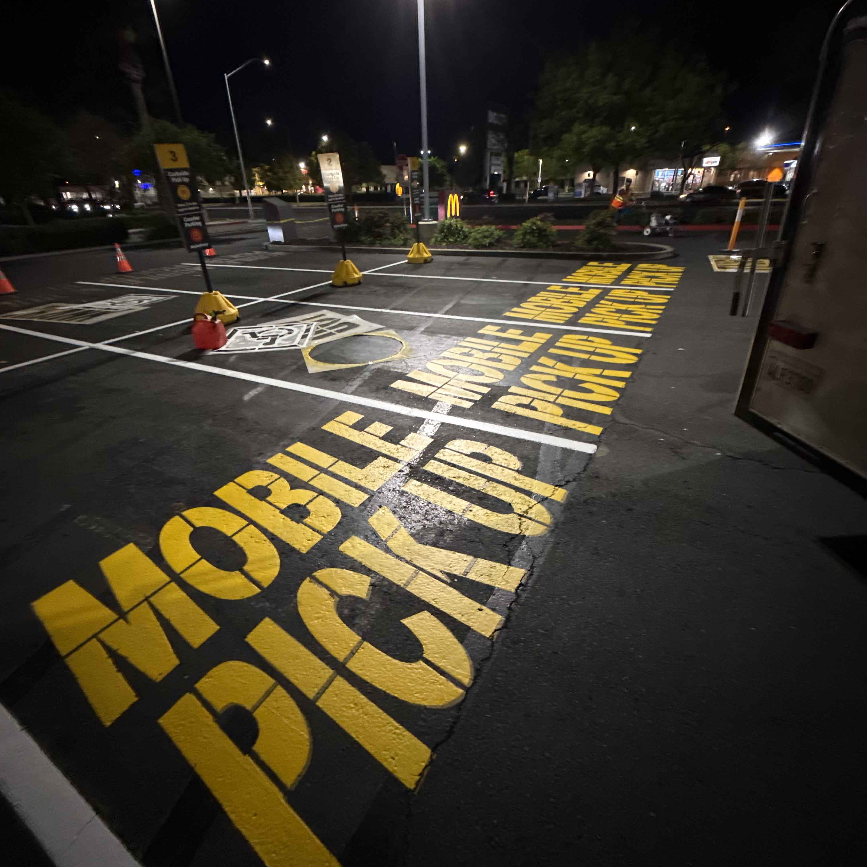 Directional pavement marking and parking lot signage
